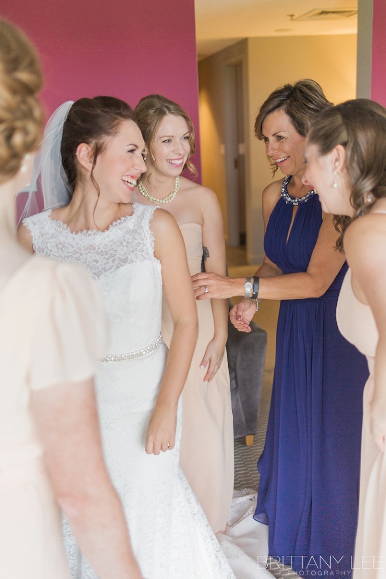 Bride getting dressed for wedding at the Brookstreet Hotel in Ottawa
