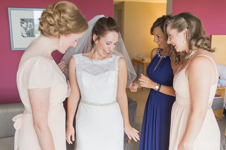 Bride getting dressed for wedding at the Brookstreet Hotel in Ottawa