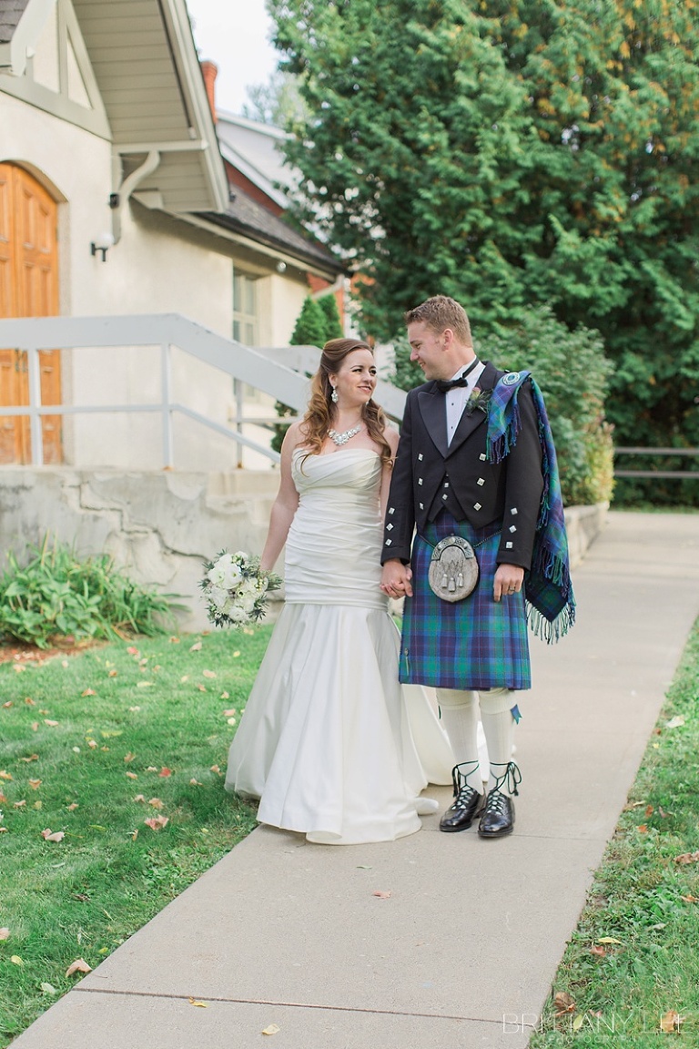 Bride in white dress and groom in Scottish kilt