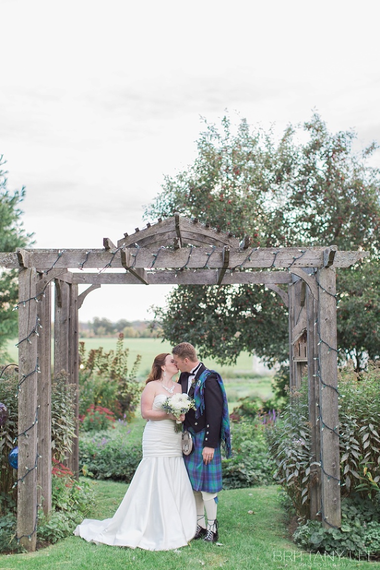 Bride in white dress and groom in Scottish kilt