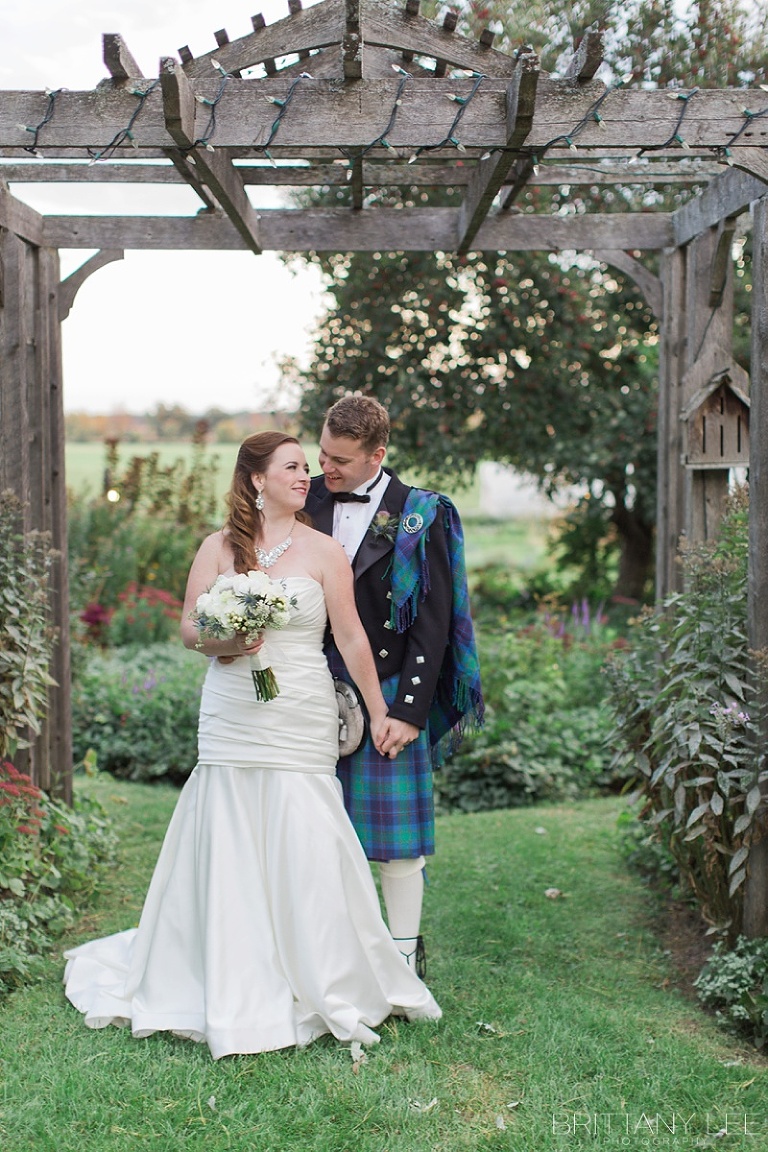 Bride in white dress and groom in Scottish kilt