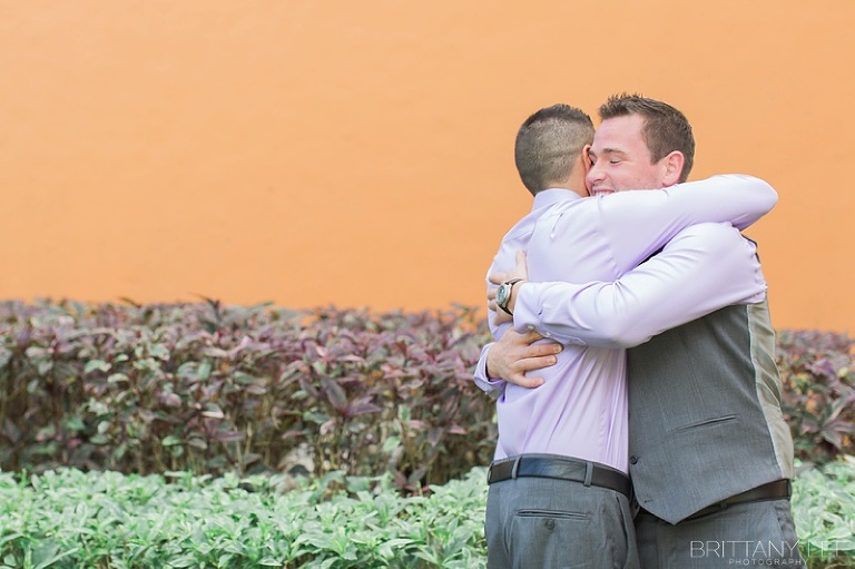 groom hugging his groomsman at a destination wedding