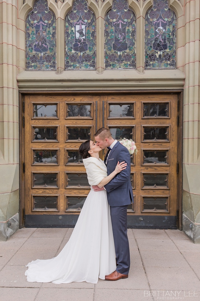 Bride and Groom kissing before wedding ceremony in Ottawa Lord Elgin Hotel
