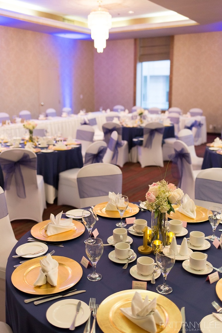 Ottawa Wedding at Lord Elgin Hotel with navy and gold accents and navy uplighting in ballroom
