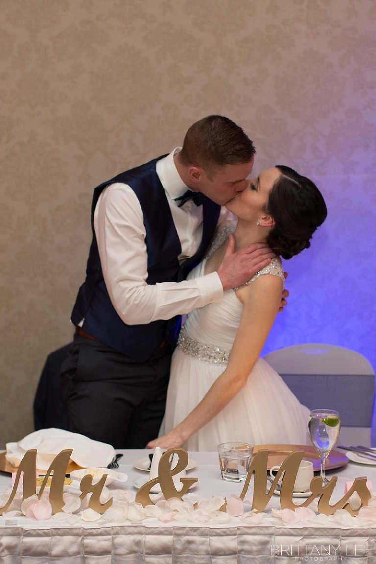 Bride and Groom kissing at Lord Elgin Hotel wedding reception