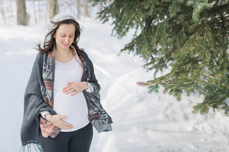 Mont Tremblant Winter Maternity Photos - pregnant lady standing in the forest