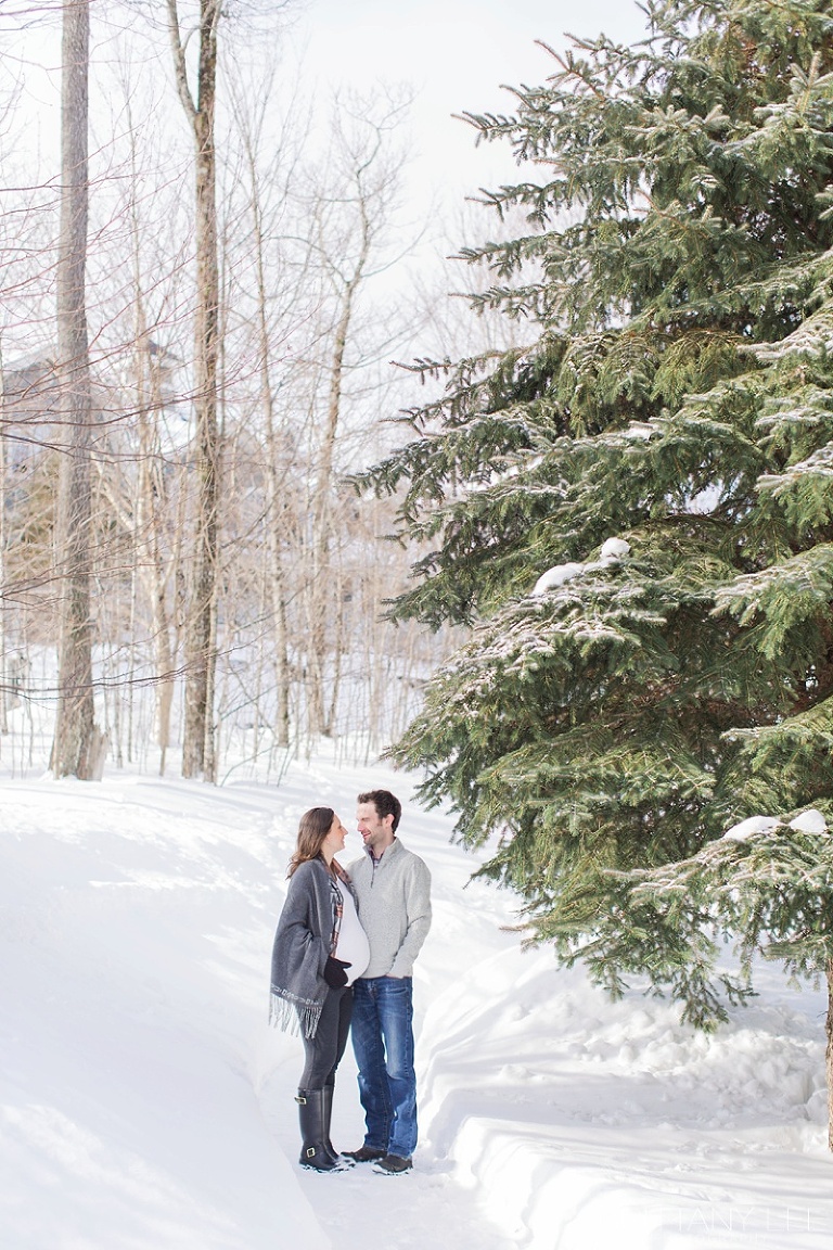 Mont Tremblant Winter Maternity Photos - couple standing in a forest