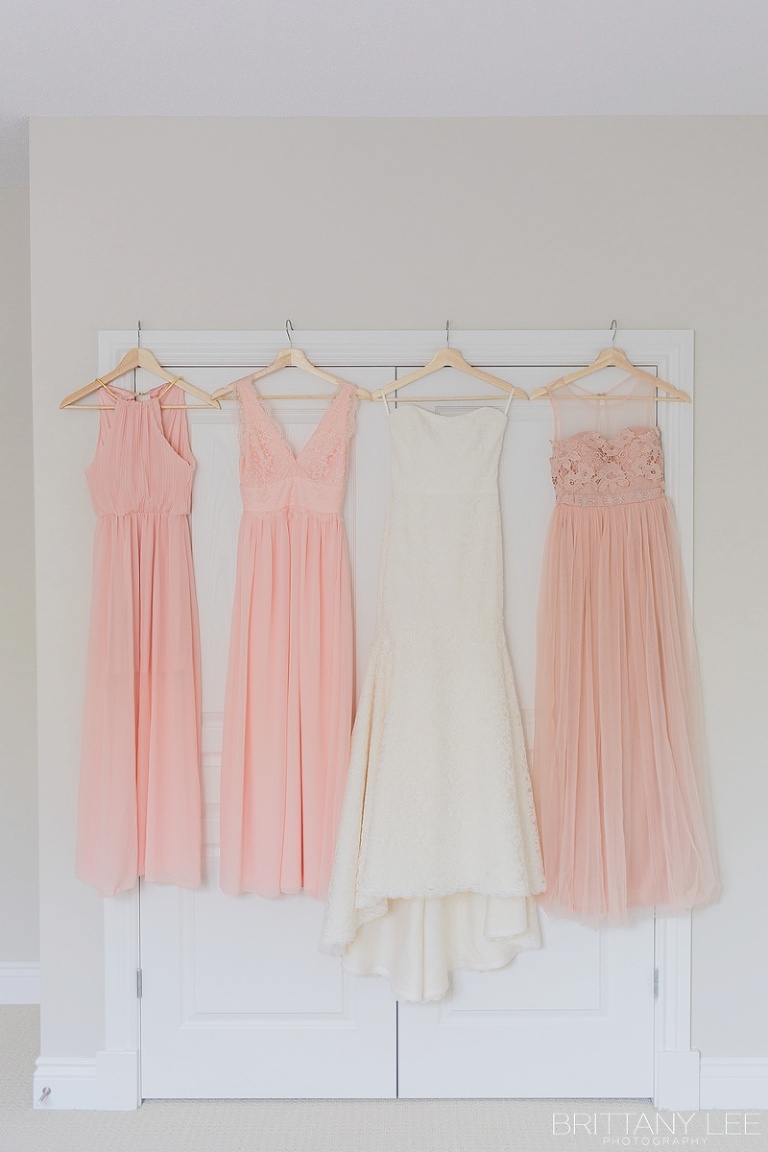 Blush Bridesmaid dresses hanging in room