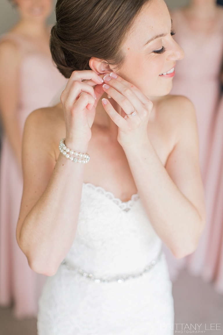 Bride putting on her Sarah Walsh Bridal Jewellery on her wedding day at Strathmere
