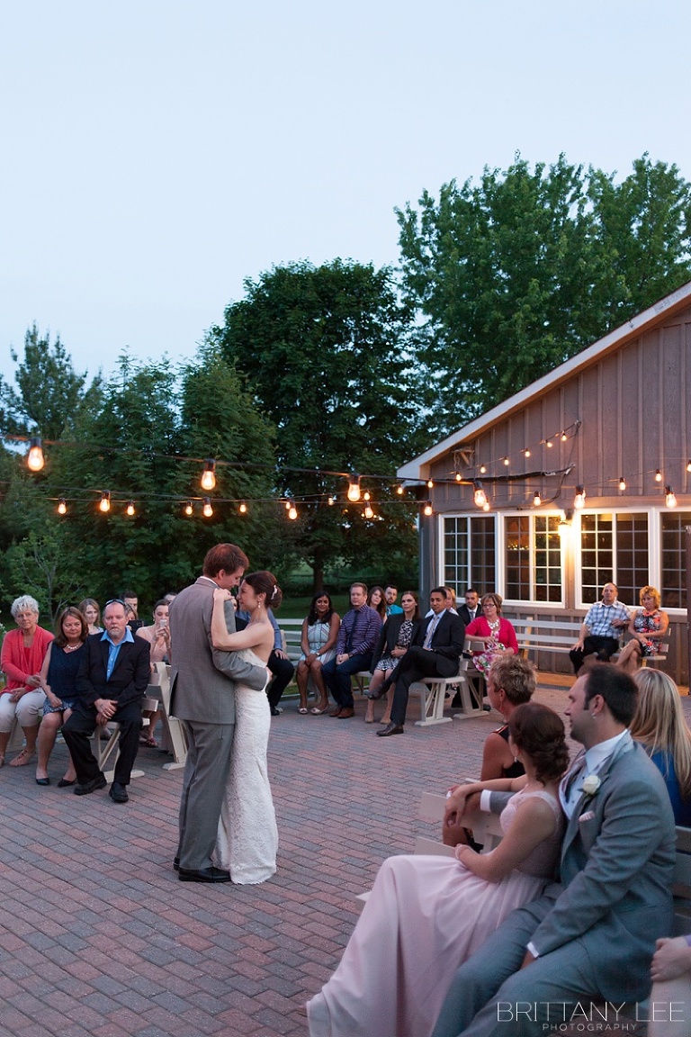 Bride and Groom first dance outside under twinkle lights at Strathmere Garden house wedding