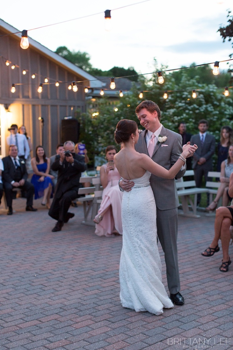Bride and Groom first dance outside under twinkle lights at Strathmere Garden house wedding