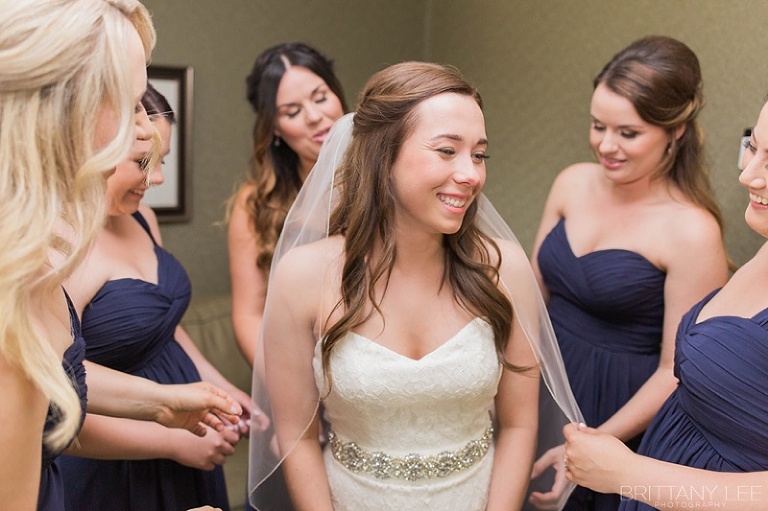 Bride getting dressed at nautical Ottawa wedding