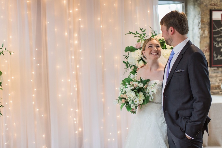 Mill Street Brew Pub Ottawa Wedding - Bride and Groom in front of white ceremony backdrop