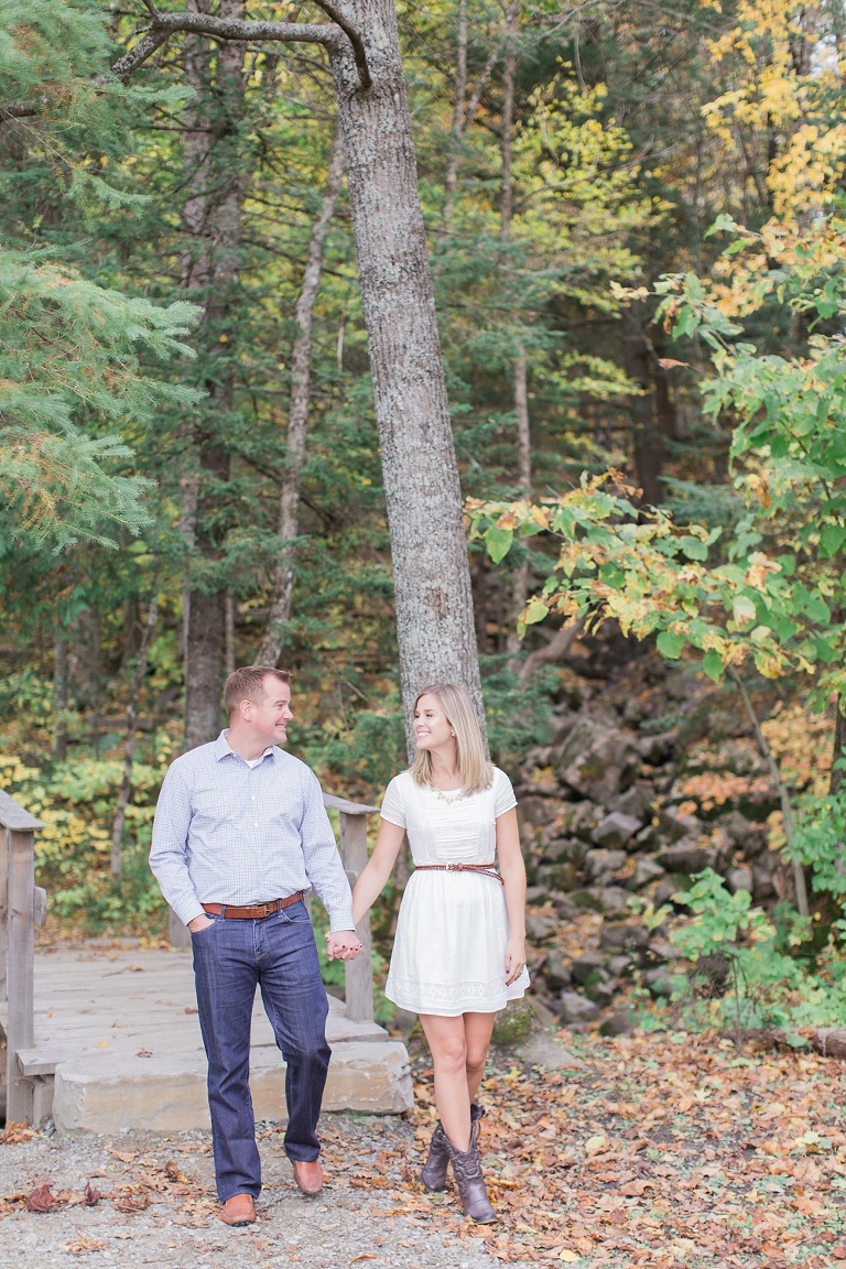 Wakefield fall engagement photos  - couple standing on little wooden bridge