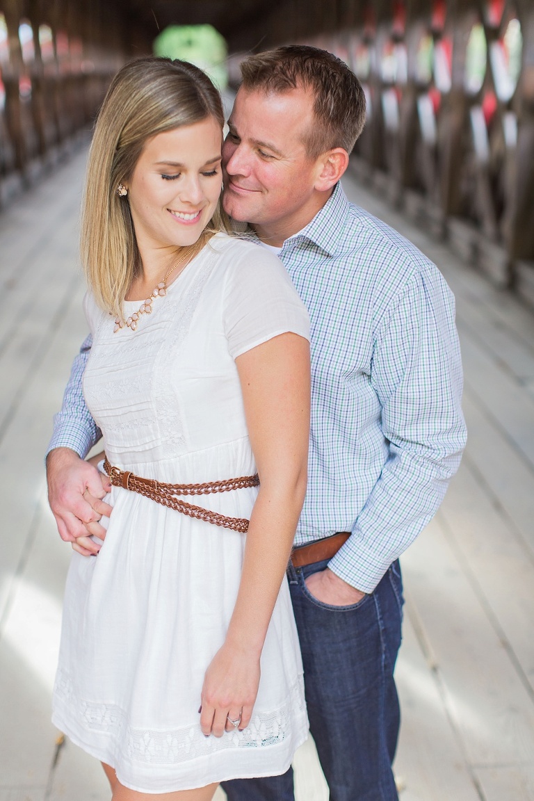Wakefield fall engagement photos  - couple underneath red wooden covered bridge