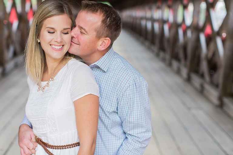 Wakefield fall engagement photos  - couple underneath red wooden covered bridge