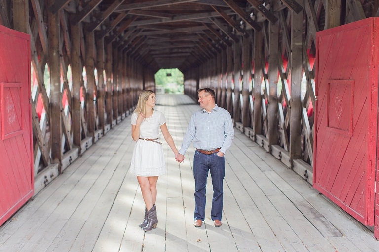 Wakefield fall engagement photos  - couple underneath red wooden covered bridge