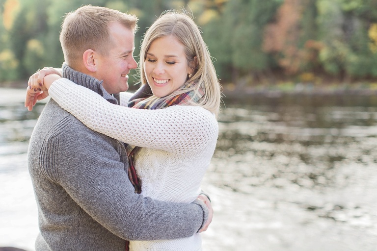Wakefield fall engagement photos  - couple standing on rocks  along the river