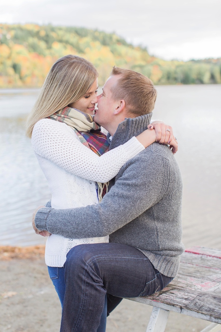 Wakefield fall engagement photos  - couple sitting on a bench by the river