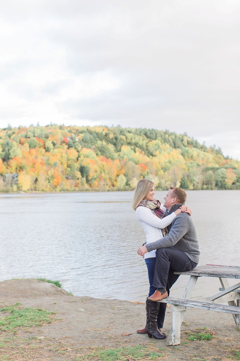 Wakefield fall engagement photos  - couple sitting on a bench by the river