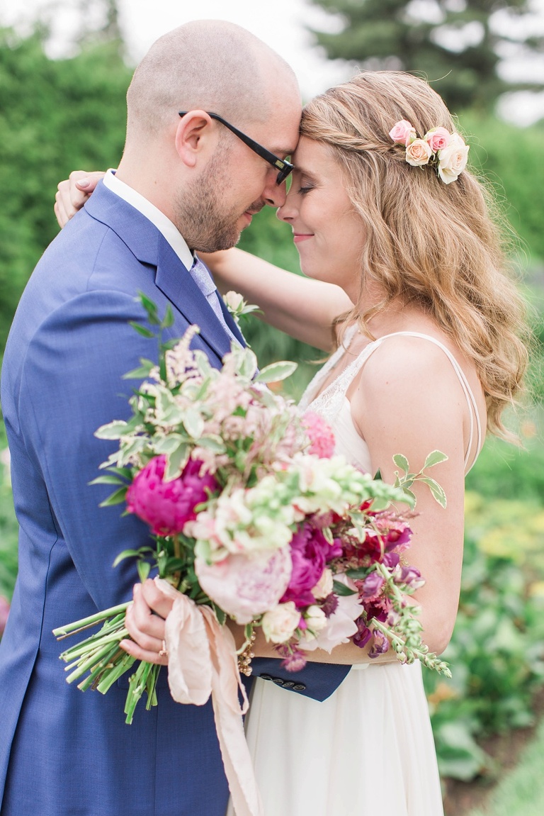 Favourite Wedding Photos from 2016 - Bride and Groom holding each other close with deep pink bridal bouquet
