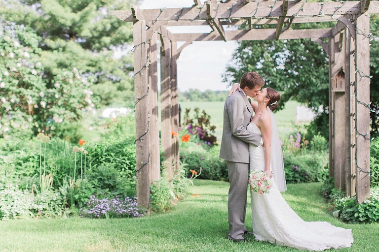 Favourite Wedding Photos from 2016 - Bride and Groom kissing under arbour at Strathmere, Ottawa
