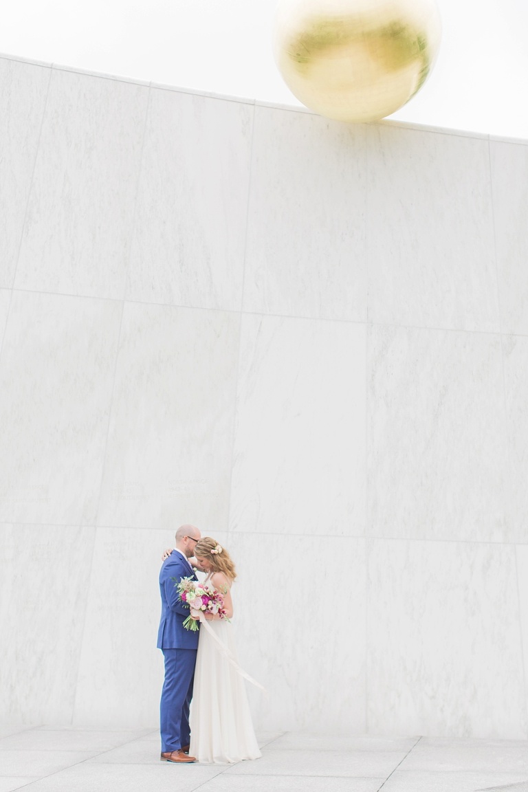 Favourite Wedding Photos from 2016 - Bride and Groom hugging each other in front of a white Ottawa monument