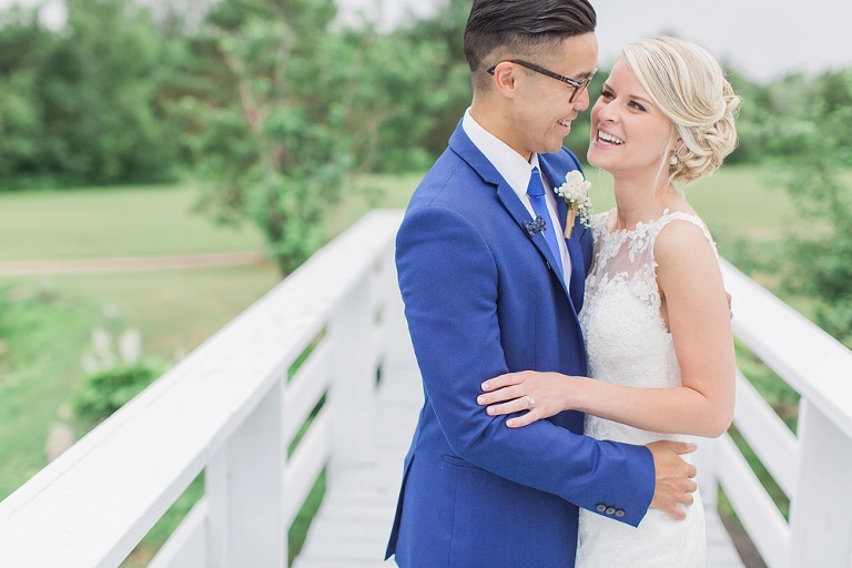 Favourite Wedding Photos from 2016 - Bride and Groom hugging and laughing on a white bridge at Orchardview, Ottawa