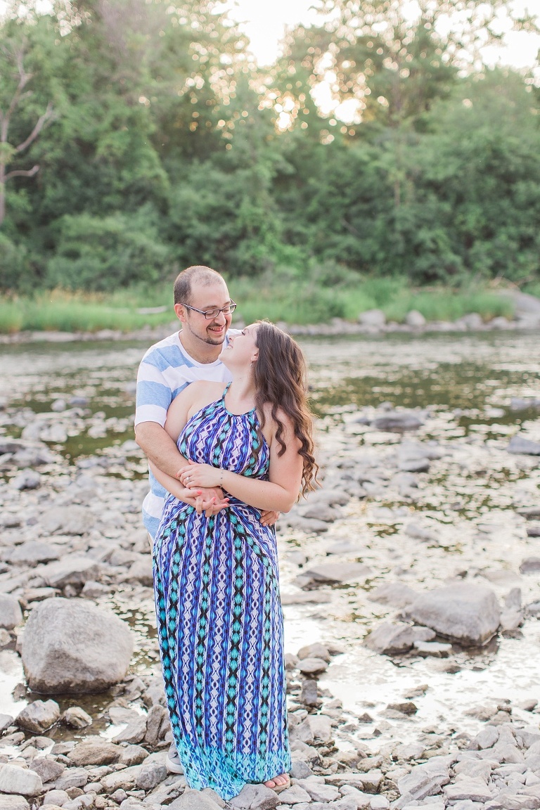 Favourite Engagement Photos from 2016 - Couple standing together and laughing along the Ottawa river 