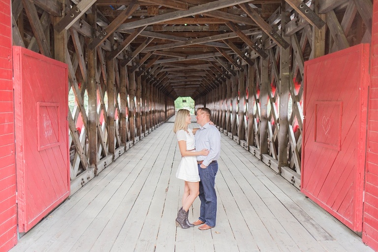 Favourite Engagement Photos from 2016 - Couple standing under a red covered bridge