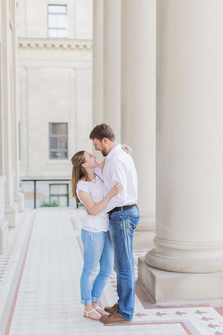 Favourite Engagement Photos from 2016 - Couple hugging by tall white pillars at University of Ottawa