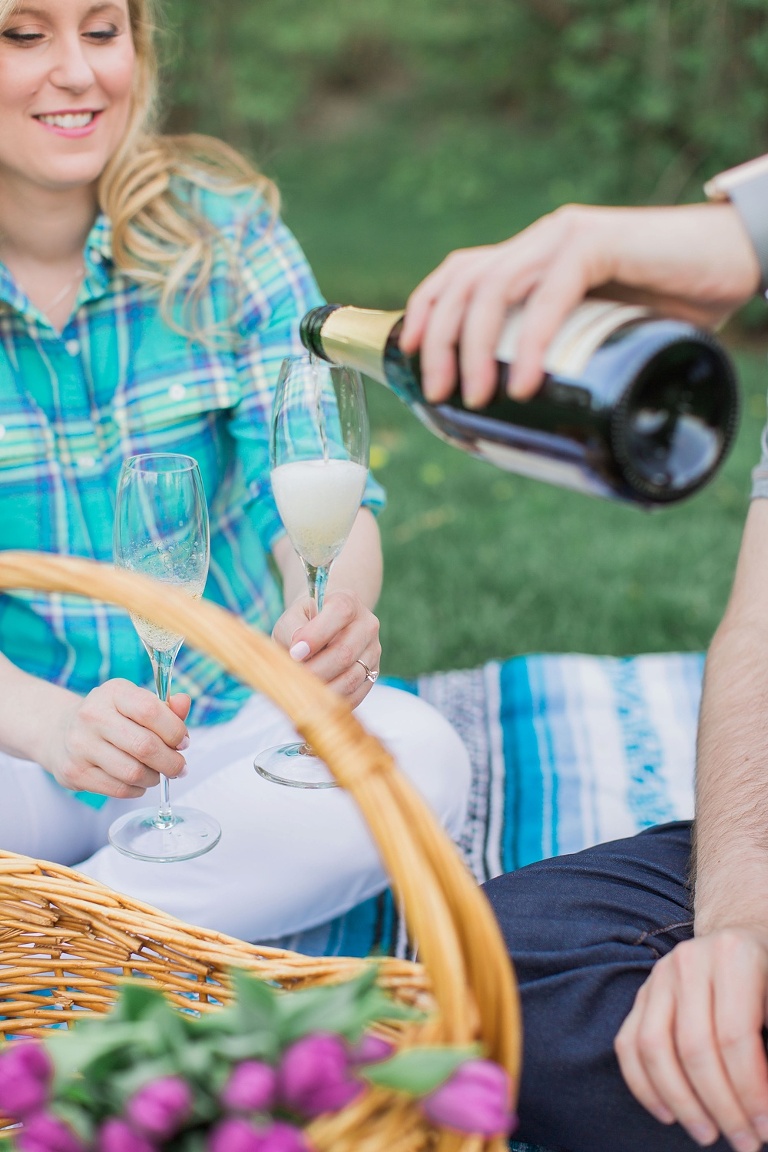 Favourite Engagement Photos from 2016 - couple pouring champagne at an engagement picnic