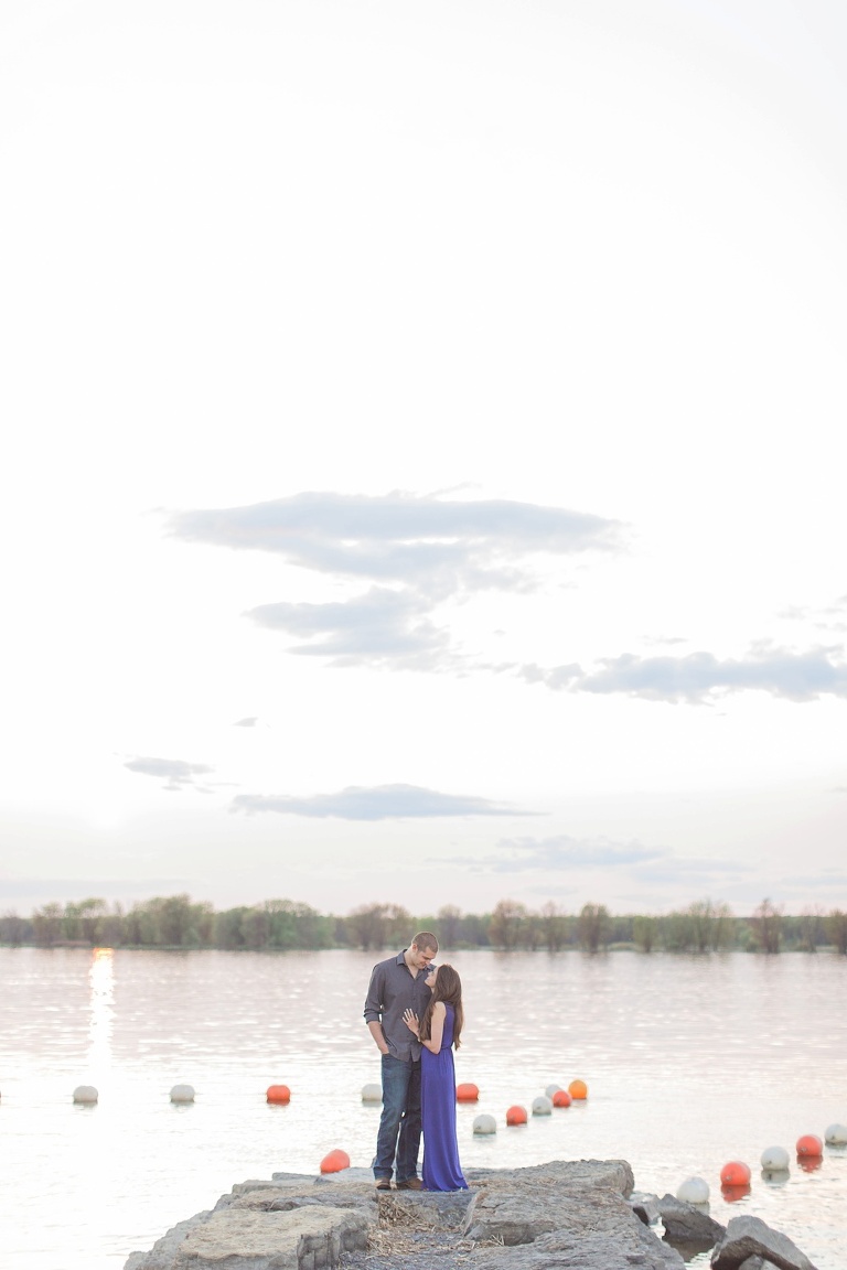 Favourite Engagement Photos from 2016 - Couple standing at the edge of dock at sunset on the Ottawa River