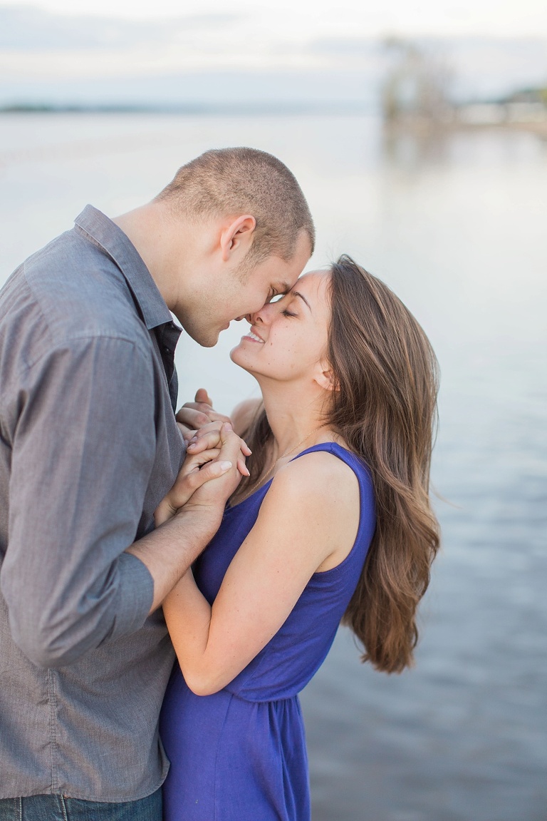 Favourite Engagement Photos from 2016 - Couple cuddled up at the edge of a dock at the Ottawa River